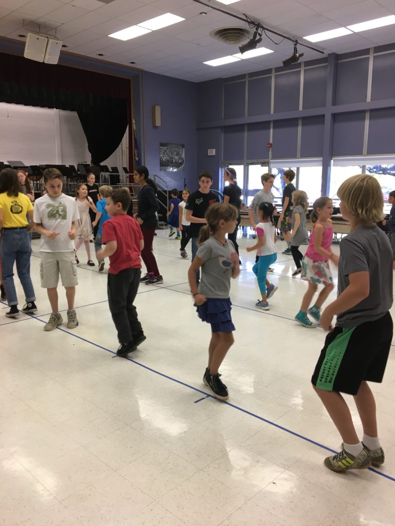 ENTA_Madagscar Day_ 8th grade & 2nd grade students work together to learn a traditional Malagasy Dance