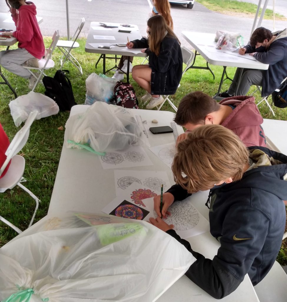 RHS Students work in outdoor tent for Mandala program